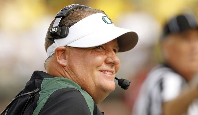 FILE - This Sept. 8, 2012 file photo shows Oregon coach Chip Kelly looking to the scoreboard during the first half of an NCAA college football game against Fresno State in Eugene, Ore. (AP Photo/Don Ryan, FIle)