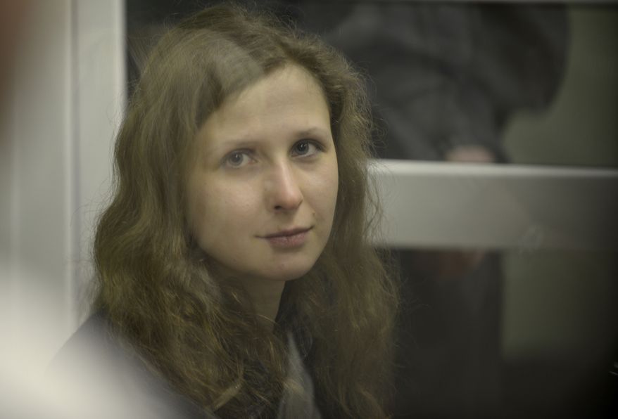 Jailed feminist punk band Pussy Riot member Maria Alekhina is seen in a cell at a courtroom in Berezniki, about 1,500 km (940 miles) northeast of Moscow on Jan. 16, 2013. A Russian court on Wednesday turned down her attempt to defer serving her sentence until her preschool son becomes a teenager. Alekhina was convicted last year along with two other band members of hooliganism motivated by religious hatred for an anti-President Vladimir Putin stunt in Russia's main cathedral. (Associated Press)