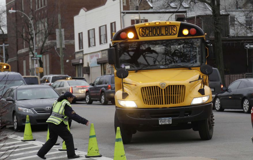 ** FILE ** A school bus arrives to drop off students in New York, Tuesday, Jan. 15, 2013. A strike by New York City school bus drivers that had been threatened for weeks will start Wednesday, Jan. 16, 2013, affecting 152,000 students, the president of the union representing the drivers announced on Monday, Jan. 14, 2013. (AP Photo/Seth Wenig)