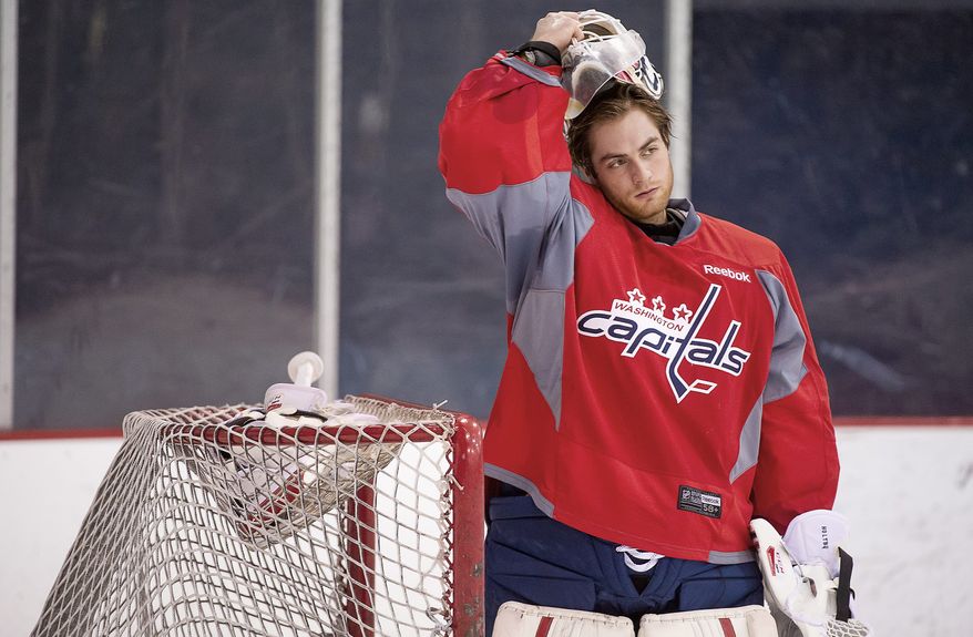 Capitals goaltender Braden Holtby recorded a 1.95 goals against average and a .935 save percentage in 14 playoff games last year. The 23-year-old is competing with Michal Neuvirth for the starting spot to open the lockout-shortened 48-game regular season. (Andrew Harnik/The Washington Times)