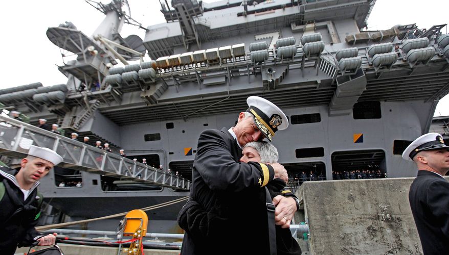 Rear Adm. Craig Faller, commander of the John C. Stennis Strike Group, is welcomed home by his wife, Martha, as the USS Stennis returned to Bremerton, Wash., in March. The stay was shortened from December to August. (Associated Press)