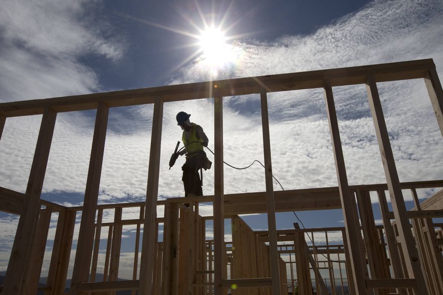 ** FILE ** In this Friday, Nov. 16, 2012, photo, construction worker Elabert Salazar works on a house frame for a new home in Chula Vista, Calif. (AP Photo/Gregory Bull)