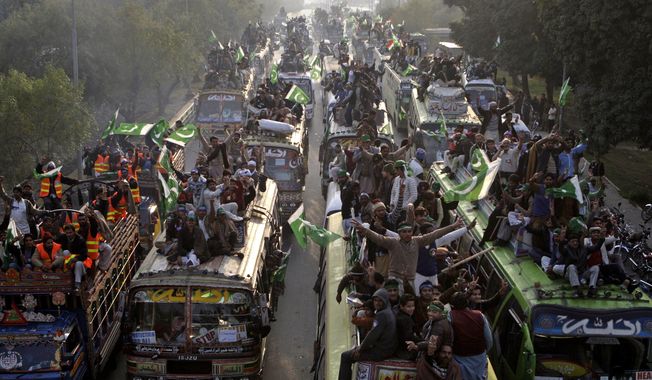 ** FILE ** Supporters of Pakistani Sunni Muslim cleric Tahir-ul-Qadri, 61, march toward the capital Islamabad, Pakistan, Sunday, Jan 13, 2013, in Pakistan. (AP Photo/K.M. Chaudary)

