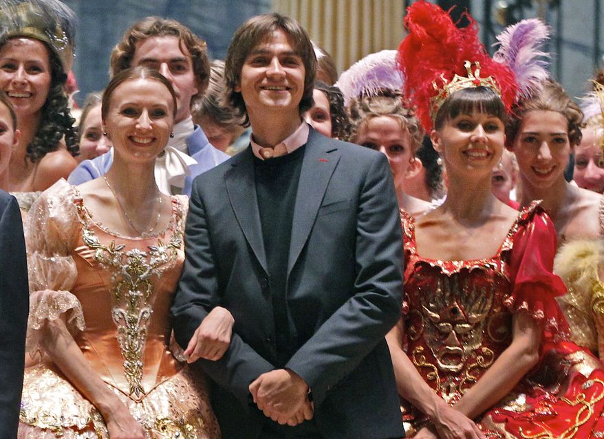 **FILE** Sergei Filin (center) poses Sept. 20, 2011, with members of the Bolshoi Theater company involved in the Sleeping Beauty ballet after a rehearsal at the Bolshoi Theater in Moscow. (Associated Press)