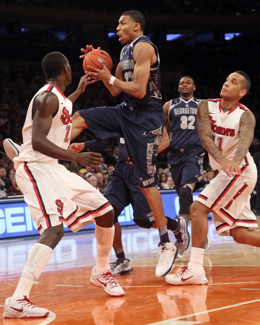 FILE -- Georgetown's Otto Porter Jr., center goes up against St. Johns' Sir Dominic Pointer, left, and D'angelo Harrison during the first half of an NCAA college basketball game, Saturday, Jan. 12, 2013, at Madison Square Garden in New York. Porter had 19 points and a season-high 14 rebounds and No. 19 Georgetown broke out of its scoring funk with a 67-51 victory. (AP Photo/Mary Altaffer)