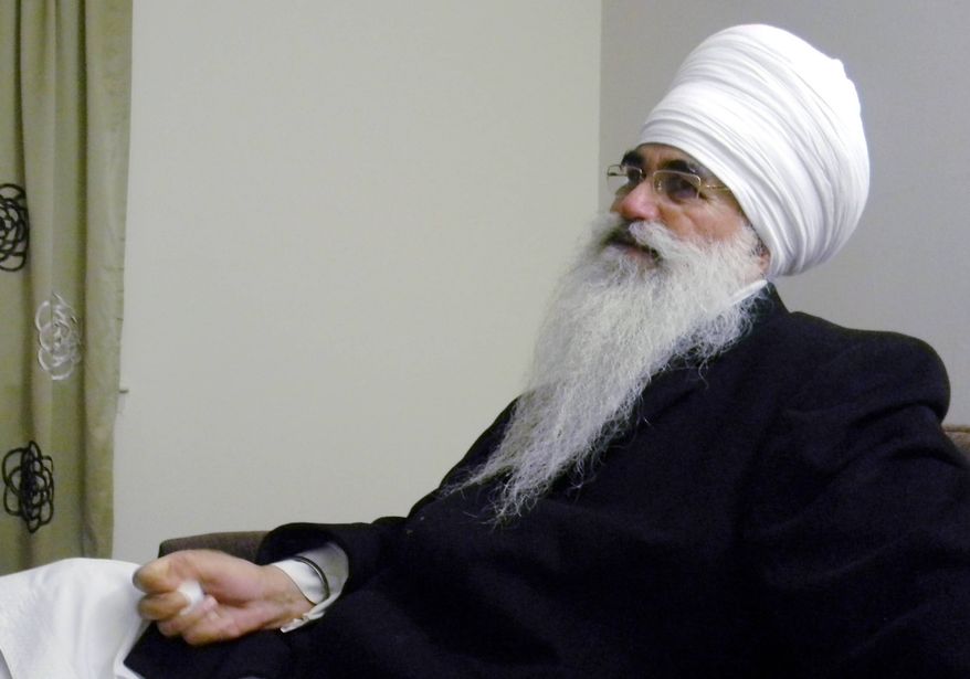 In this March 2012 photo provided by his family, Punjab Singh poses at a Sikh temple in Glen Rock, N.J. Singh was critically injured in a shooting rampage at a Sikh temple in Oak Creek, Wis., in August 2012 that left six people dead. The 65-year-old Sikh priest had remained largely unresponsive at a Wisconsin care facility until January 2013 when he began showing signs of cognitive improvement. (AP Photo/Family photo)