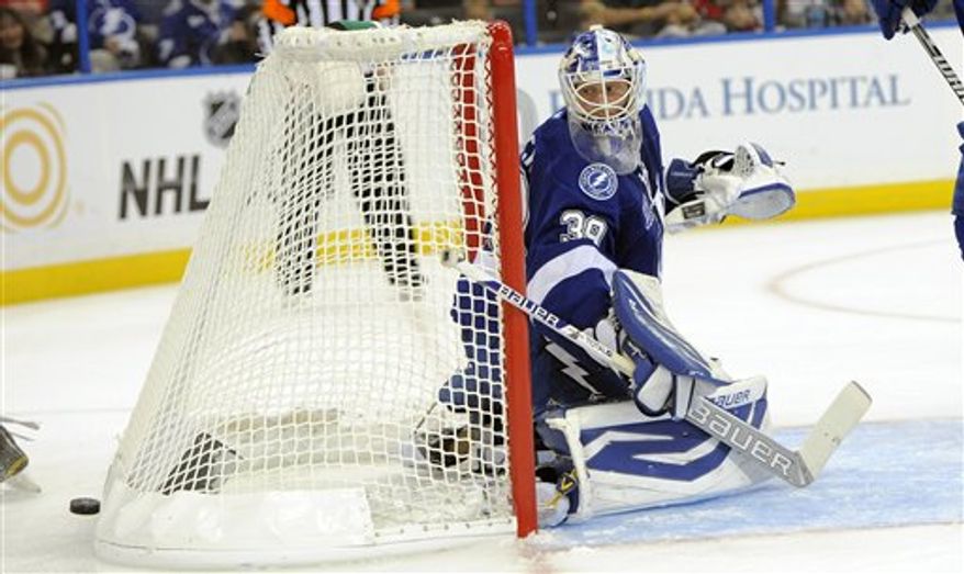 Tampa Bay Lightning goalie Anders Lindback, of Sweden, looks back at the puck during the third period of an NHL hockey game against the Washington Capitals on Saturday, Jan. 19, 2013, in Tampa, Fla. The Lightning won 6-3. (AP Photo/Brian Blanco)
