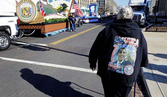 Luci Brown of South Bend, Ind., looks at the floats prepared for the 57th Presidential Inaugural Parade, Sunday, Jan. 20, 2013 in Washington. Thousands are planning to march in the 57th Presidential Inauguration parade after the ceremonial swearing-in of President Barack Obama on Monday. (AP Photo/Alex Brandon)