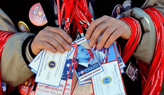 A vendor holds items for sale on the National Mall with the U.S. Capitol prepared for the ceremonial swearing-in of President Barack Obama, the 57th Presidential Inaugural, Sunday, Jan. 20, 2013 in Washington. (AP Photo/Alex Brandon)