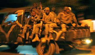 Malian soldiers are jubilant as they return to Niono, Mali, from Diabaly, some 300 miles north of the capital, Bamako, on Saturday, Jan. 19, 2013. (AP Photo/Jerome Delay)