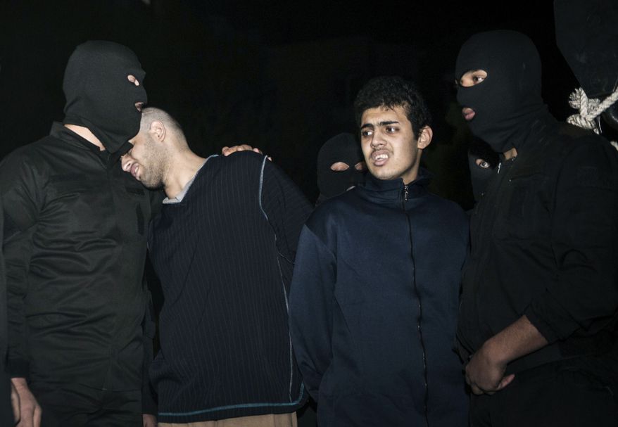 Alireza Mafiha (second from left) leans his head on the shoulder of a security officer moments before his execution along with Mohammad Ali Sarvari (second from right) in Tehran on Sunday, Jan. 20, 2013. Iran executed the two men publicly after a posting on YouTube in December showed the two men robbing and assaulting a man with a machete on a street in the Iranian capital. (AP Photo/ISNA, Amir Pourmand)