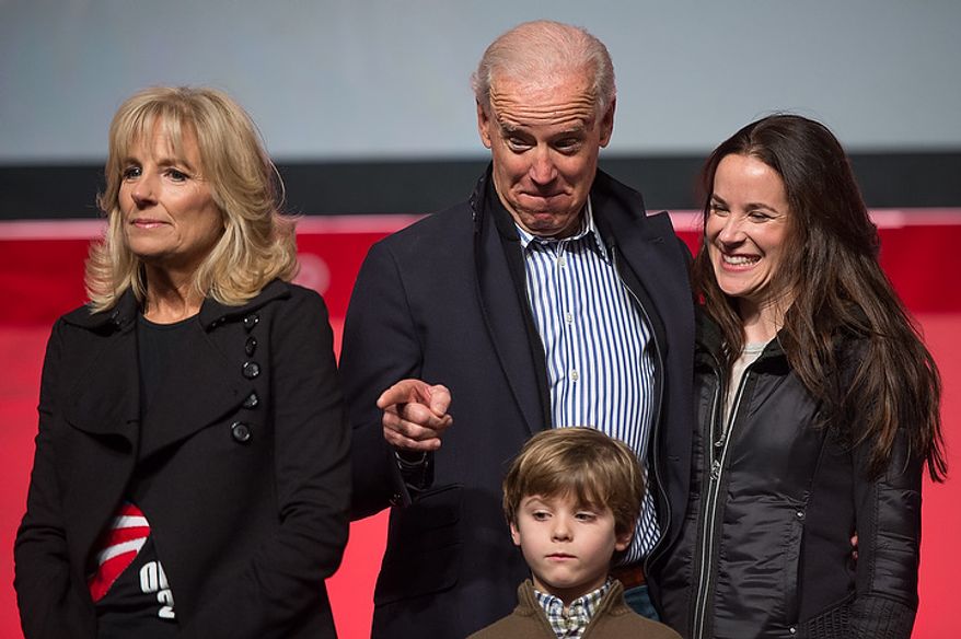 Vice President Joseph Biden, his wife Jill Biden, left, and their family take the stage to speak to volunteers who put together service packages for members of the armed services abroad during the National Day of Service at the D.C. Armory, Washington, D.C., Saturday, January 19, 2013. Non-profit groups are running hundreds of service projects for the Martin Luther King Jr. weekend. (Andrew Harnik/The Washington Times)