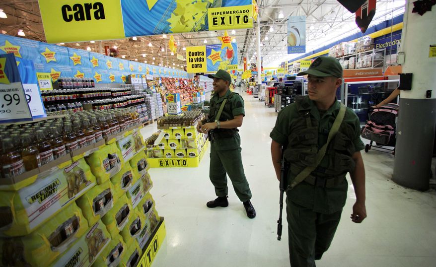 Venezuelan soldiers check prices at a supermarket in Caracas that the Chavez government has accused of raising costs. In a country riven by political strife, the military has been a unifying force. (Associated Press)