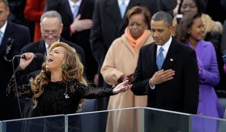 President Obama holds his hand over his heart at the swearing-in ceremony for his second term Monday while pop star Beyonce sings the national anthem. James Taylor and Kelly Clarkson also sang during the ceremony at the Capitol. (Associated Press)