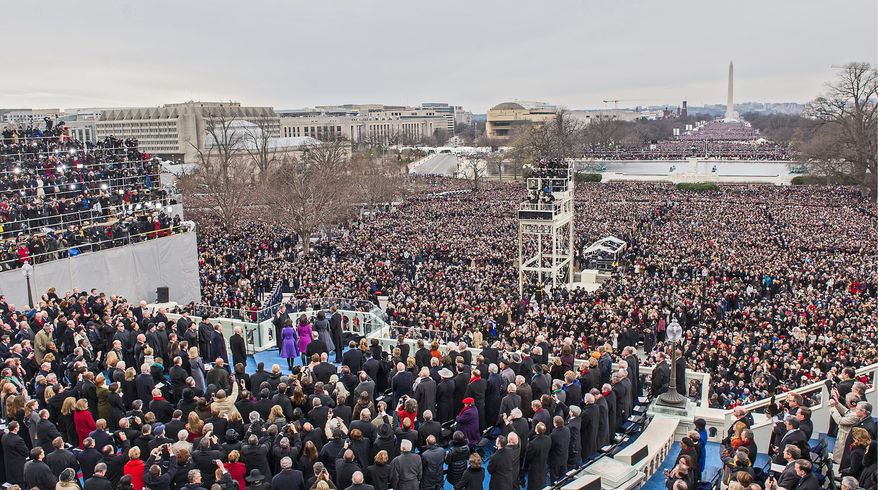 Before a crowd stretching down the Mall, President Obama takes the oath of office and gives a relatively brief inaugural address. (Andrew S. Geraci/The Washington Times)