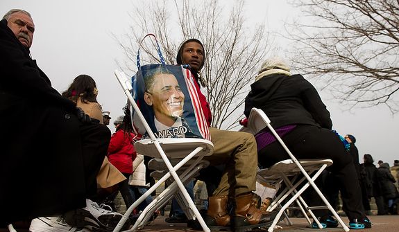 Members of the crowd wait for President Barack Obama to be sworn in for his second term on the West Lawn of the U.S. Capitol Building at the 57th Presidential Inauguration Ceremony, Washington, D.C., Monday, January 21, 2013. (Andrew Harnik/The Washington Times)