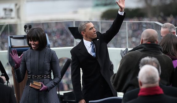 U.S. President Barack Obama waves after being sworn in by Supreme Court Chief Justice John Roberts as First lady Michelle Obama looks on during the public ceremonial inauguration on the West Front of the U.S. Capitol January 21, 2013 in Washington, DC.   Barack Obama was re-elected for a second term as President of the United States.  (Photo by POOL Win McNamee/Getty Images)