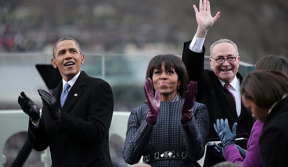 (L-R) U.S. President Barack Obama, First lady Michelle Obama and U.S. Sen. Charles Schumer (D-NY) clap during the presidential inauguration on the West Front of the U.S. Capitol January 21, 2013 in Washington, DC.   Barack Obama was re-elected for a second term as President of the United States.  (Photo by POOL Win McNamee/Getty Images)