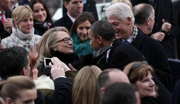 U.S. President Barack Obama greets Secretary of State Hillary Clinton and former president Bill Clinton during the presidential inauguration on the West Front of the U.S. Capitol January 21, 2013 in Washington, DC.   Barack Obama was re-elected for a second term as President of the United States.  (Photo by POOL Win McNamee/Getty Images)