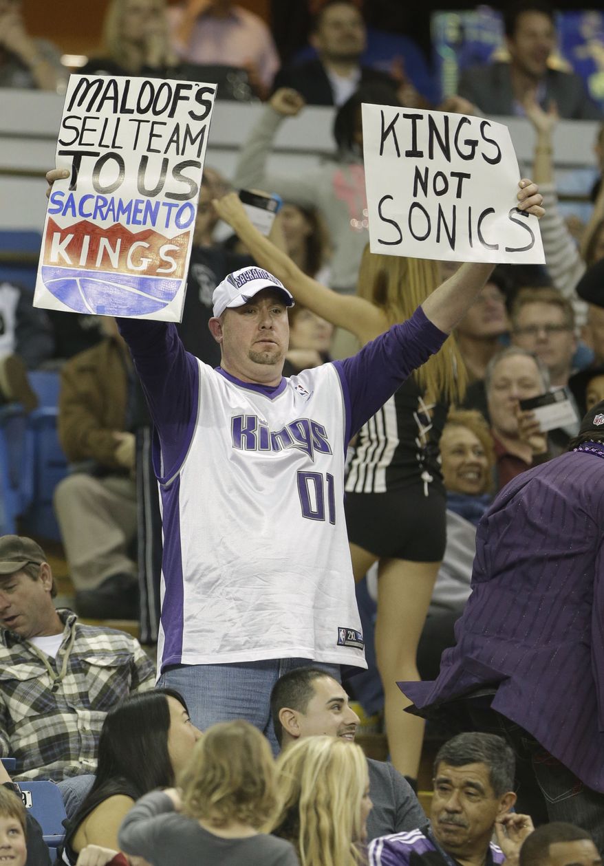 Sacramento Kings fan Darren Fitch calls on the Maloof family, owners of the Kings to sell the team to local buyers during a timeout in the Kings game agains the Dallas Mavericks in Sacramento, Calif., Thursday, Jan. 10, 2012. Word of the possible sale of the team to a group that would move the franchise to Seattle has Kings fan showing their support with hopes they will remain in Sacramento. The Mavericks won in overtime 117-112.(AP Photo/Rich Pedroncelli)