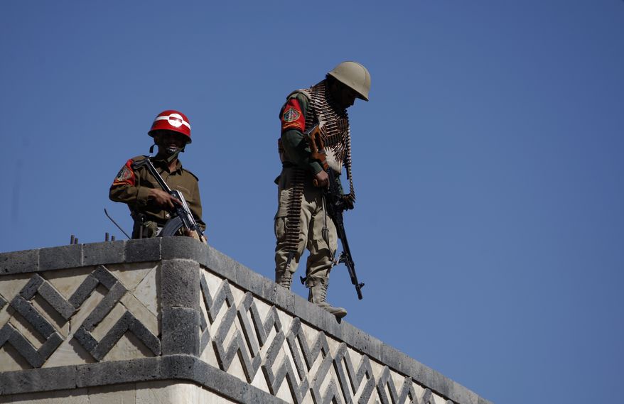 Yemeni soldiers stand guard on the rooftop of a state security court during a trial of suspected al Qaeda militants in Sanaa, Yemen, on Monday, Jan. 21, 2013. A Yemen security official said an explosion Sunday in the province of Bayda had killed at least 13 suspected al Qaeda militants. (AP Photo/Hani Mohammed)
