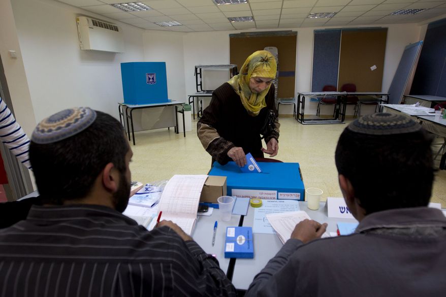 An Arab Israeli woman casts her vote during legislative elections in the central Israeli town of Tira on Tuesday, Jan. 22, 2013. (AP Photo/Ariel Schalit)