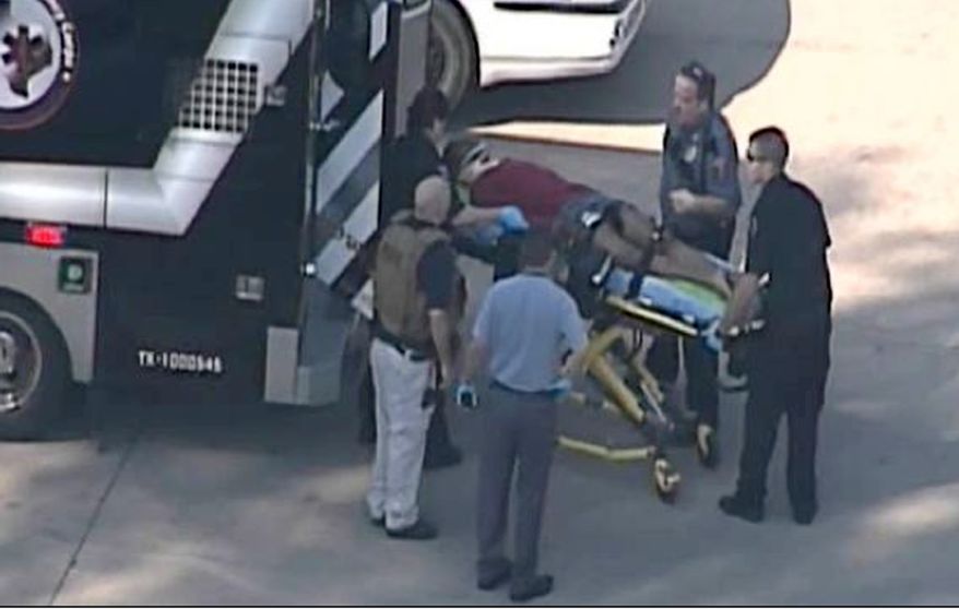 In this frame grab provided by KPRC Houston, an unidentified person is transported by emergency personnel at Lone Star College on Jan. 22, 2013, in Houston, where law enforcement officials say the community college is on lockdown amid reports of a shooter on campus. (Associated Press/Courtesy KPRC TV)