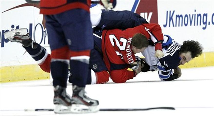 Washington Capitals center Matt Hendricks (26) brings Winnipeg Jets right wing Chris Thorburn (22) to the ice during a fight in the third period of an NHL hockey game Tuesday, Jan. 22, 2013 in Washington. The Jets won 4-2. (AP Photo/Alex Brandon)