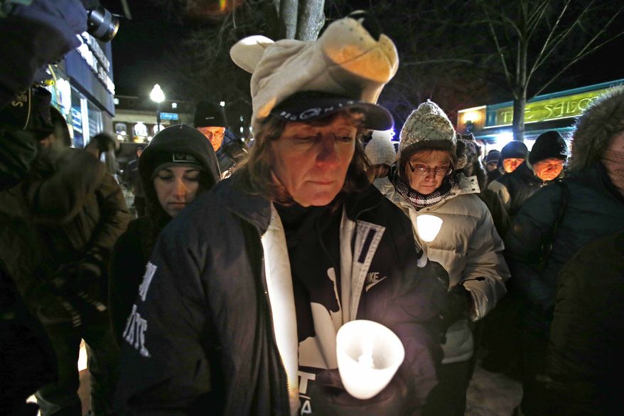 Kim Gasper (center), of Bellefonte, Pa., attends a candlelight memorial in State College, Pa., on Jan. 22, 2013, the first anniversary of the death of former Penn State head football coach Joe Paterno. (Associated Press)