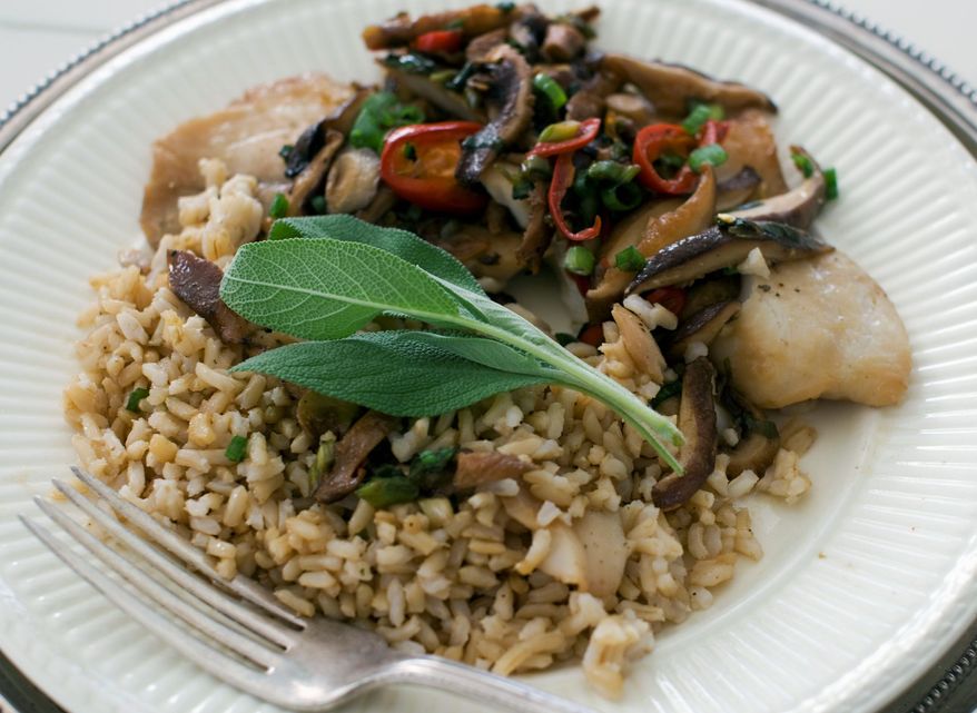 Chinese-style steamed tilapia is topped with a sauce made with shiitake mushrooms. (Associated Press)