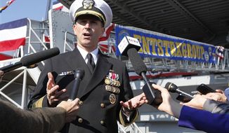 ** FILE ** Adm. Jonathan Greenert, chief of naval operations, gestures as he address the media in front of the USS Enterprise at Naval Station Norfolk on Saturday, Dec. 1, 2012, in Norfolk, Va., before an inactivation ceremony for the Enterprise, the first nuclear-powered aircraft carrier. The ship served in the fleet for 51 years. (AP Photo/Steve Helber)
