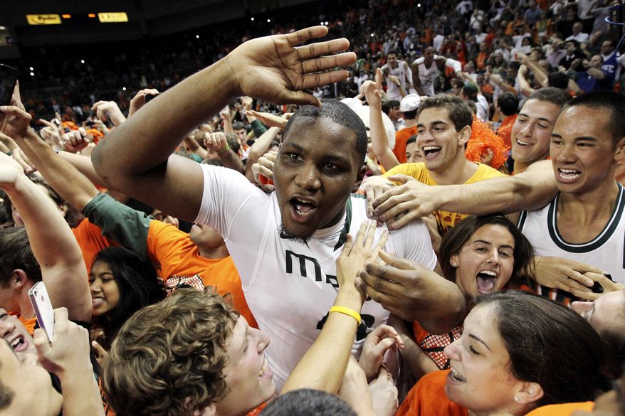 Miami's Reggie Johnson celebrates with fans after defeating Duke 90-63 in an NCAA college basketball game in Coral Gables, Fla., Wednesday, Jan. 23, 2013. (AP Photo/The Miami Herald, Charlie Trainor)