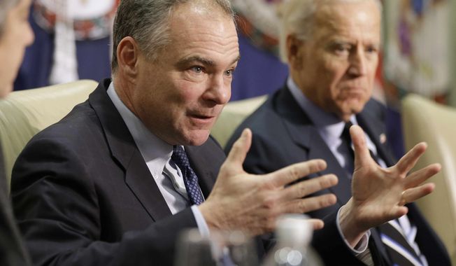 ** FILE ** Sen. Tim Kaine, Virginia Democrat, left, accompanied by Vice President Joseph R. Biden, gestures during a roundtable discussion on gun violence, Friday, Jan. 25, 2013, at Virginia Commonwealth University in Richmond, Va. The panelists included officials who worked on the aftermath of the Virginia Tech shootings. (AP Photo/Steve Helber)