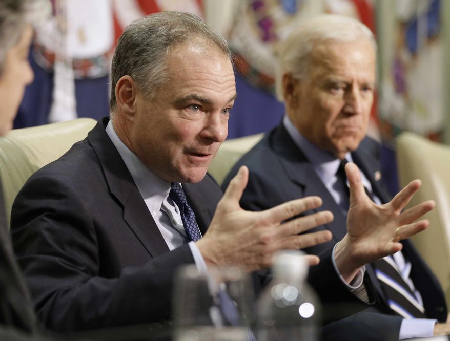 ** FILE ** Sen. Tim Kaine, Virginia Democrat, left, accompanied by Vice President Joseph R. Biden, gestures during a roundtable discussion on gun violence, Friday, Jan. 25, 2013, at Virginia Commonwealth University in Richmond, Va. The panelists included officials who worked on the aftermath of the Virginia Tech shootings. (AP Photo/Steve Helber)
