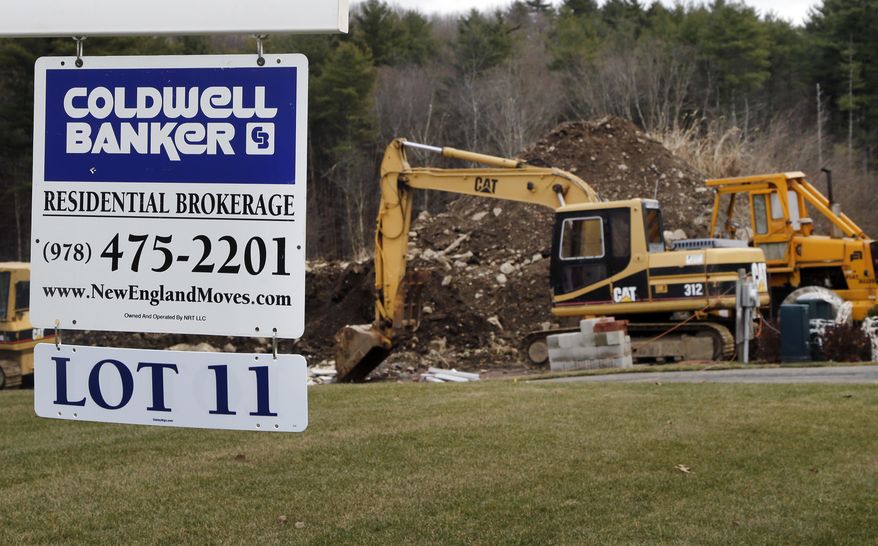 **FILE** A sign hangs Dec. 20, 2012, in North Andover, Mass., where a house is under construction. (Associated Press)