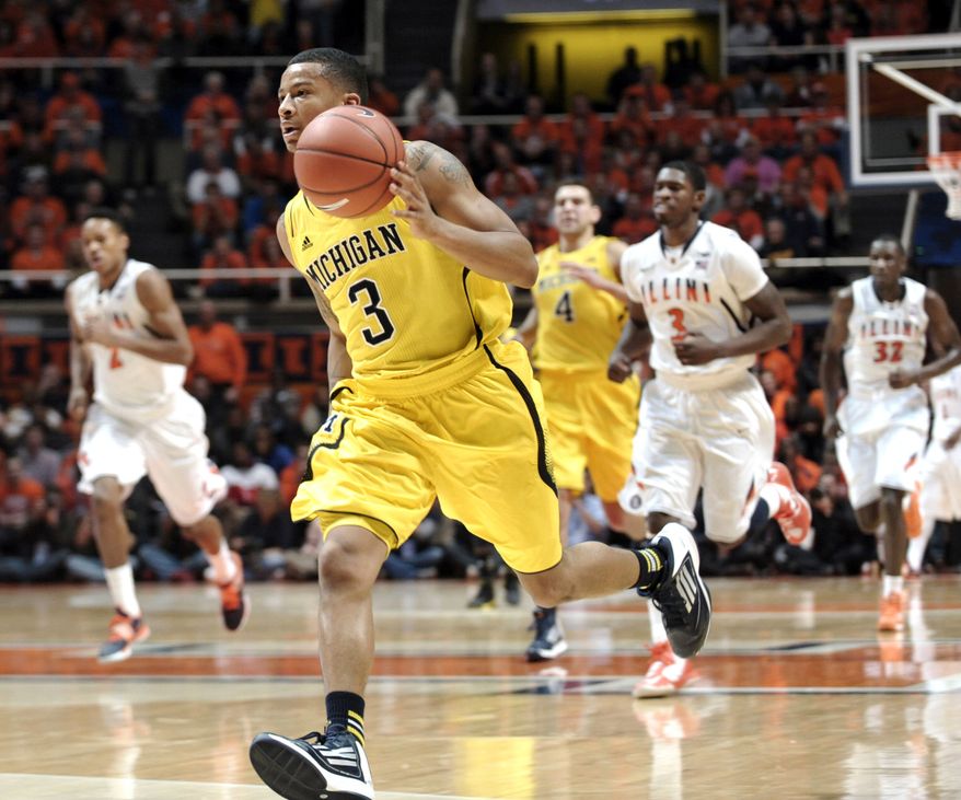 Michigan's Trey Burke (3) leads a fast break against Illinois during the second half of an NCAA college basketball game, Sunday, Jan. 27, 2013, in Champaign, Ill. Michigan won 74-60. (AP Photo/John Dixon)