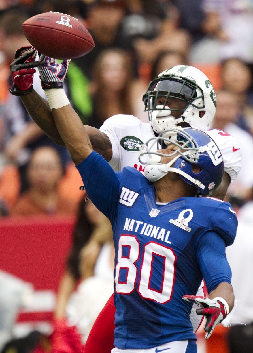 New York Jets cornerback Antonio Cromartie, top, of the AFC breaks up a pass intended for New York Giants wide receiver Victor Cruz (80) of the NFC in the fourth quarter of the NFL football Pro Bowl game in Honolulu, Sunday, Jan. 27, 2013. The NFC won 62-35. (AP Photo/Eugene Tanner)