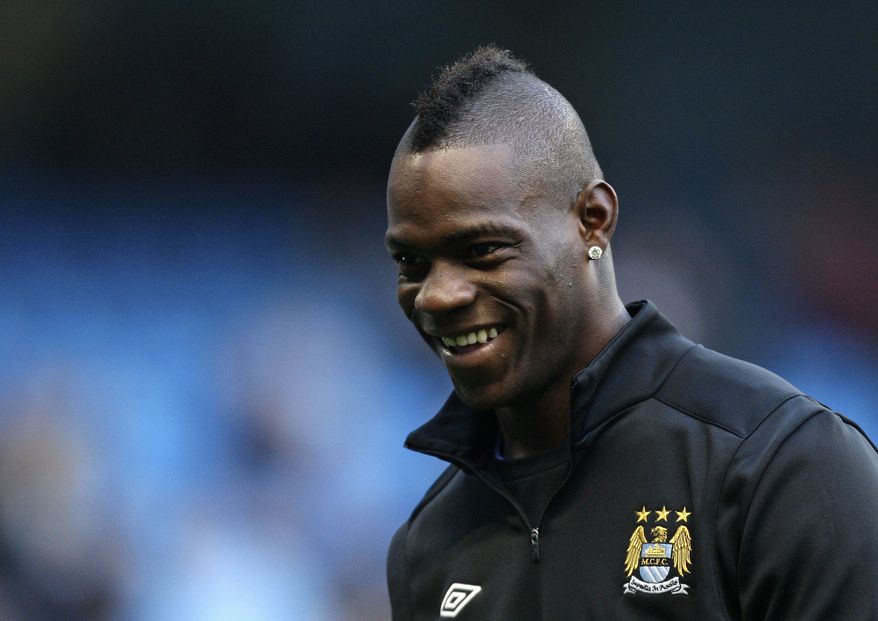 FILE - this Jan. 5, 2013 file photo shows Manchester City's Mario Balotelli smiling ahead of the English FA Cup 3rd round soccer match against Watford at The City of Manchester Stadium, Manchester, England. AC Milan says Tuesday, Jan. 29, 2013 that it has reached an agreement with Manchester City to sign Mario Balotelli and the Italy striker will undergo a medical on Wednesday. Balotelli is then expected to sign a four-and-a-half year deal with Milan, until 2017. (AP Photo/Jon Super, files)