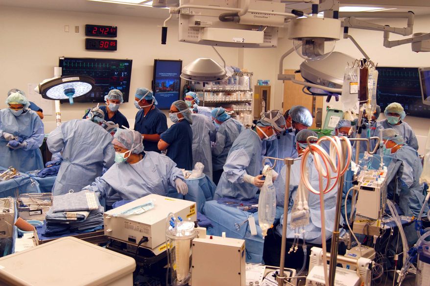 In a Dec. 18, 2012, photo provided by Johns Hopkins Medical, a surgical team at Johns Hopkins Hospital in Baltimore works on a double-arm transplant for U.S. Army infantryman Brendan Marroco, 26, who lost all four limbs in Iraq. The transplants are only the seventh double-hand or double-arm transplant ever conducted in the United States. The infantryman was injured by a roadside bomb in 2009. (AP Photo/Johns Hopkins Medical)