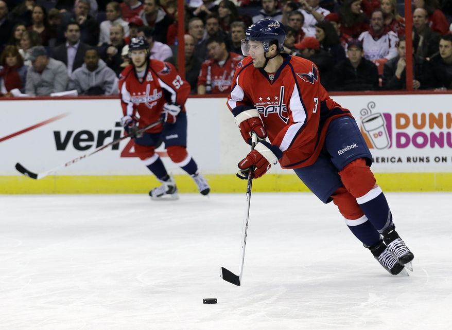 Washington Capitals defenseman Tom Poti (3) skates with the puck in the second period of an NHL hockey game against the Montreal Canadiens Thursday, Jan. 24, 2013 in Washington. (AP Photo/Alex Brandon)