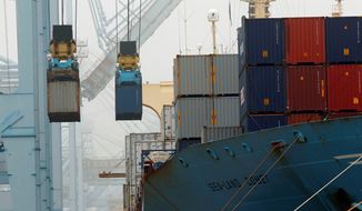 **FILE** Cargo ships are unloaded in December at the Port of Los Angeles. (Associated Press)