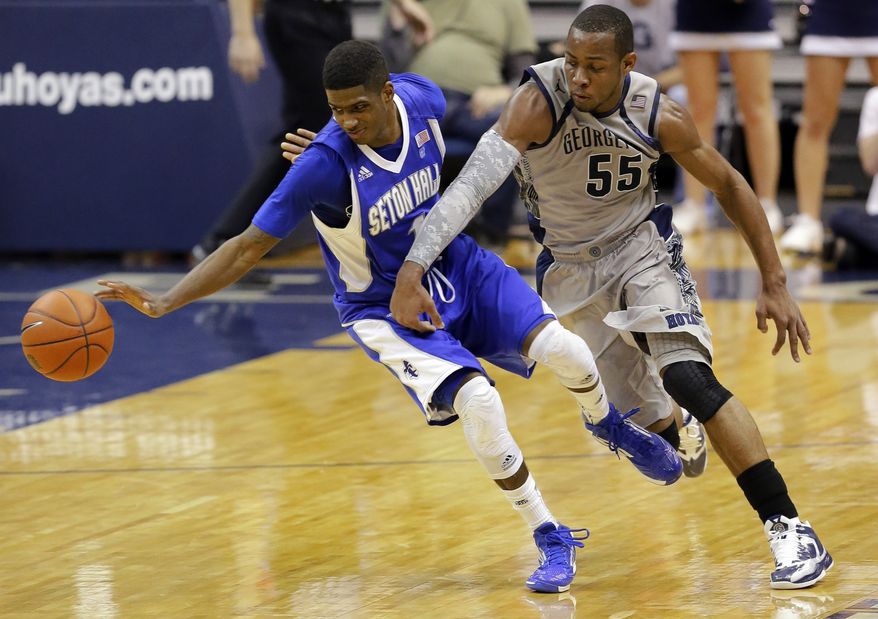 Seton Hall guard Aaron Cosby (1) goes for a loose ball with Georgetown guard Jabril Trawick during the second half of Georgetown's 74-52 win on Jan. 30, 2013, in Washington. (Associated Press)