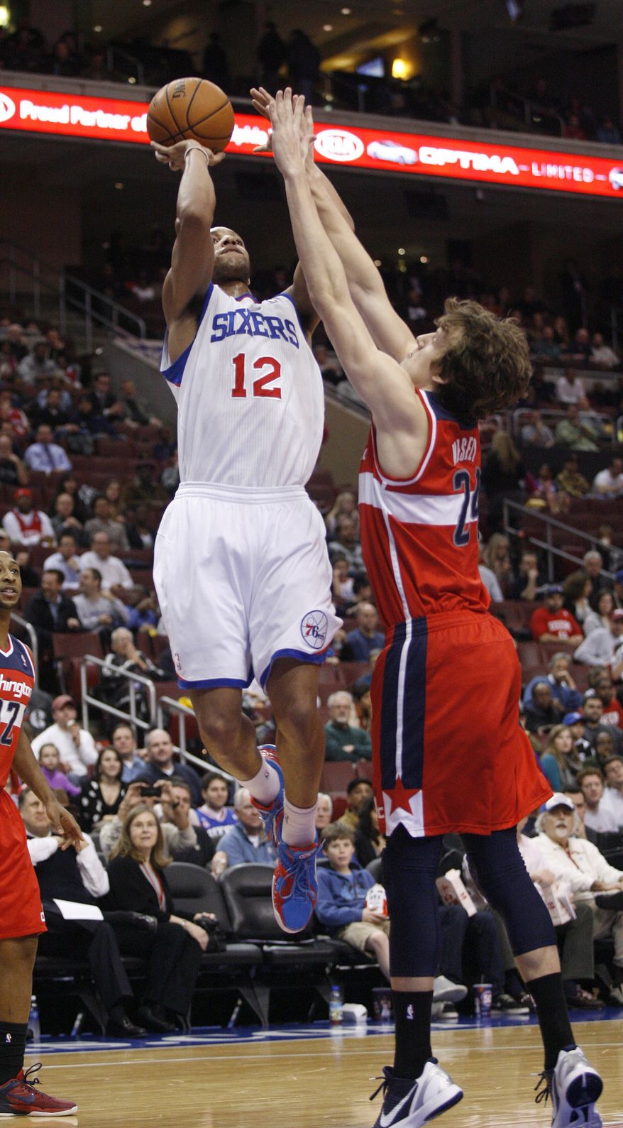 Washington Wizards' Jan Vesely (24) defends as Philadelphia 76ers' Evan Turner shoots during the first half of the 76ers' 92-84 win on Jan. 30, 2013, in Philadelphia. (Associated Press)