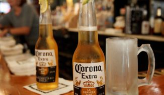 ** FILE ** This Jan. 31, 2013, file photo shows two Corona beers. (Associated Press)
