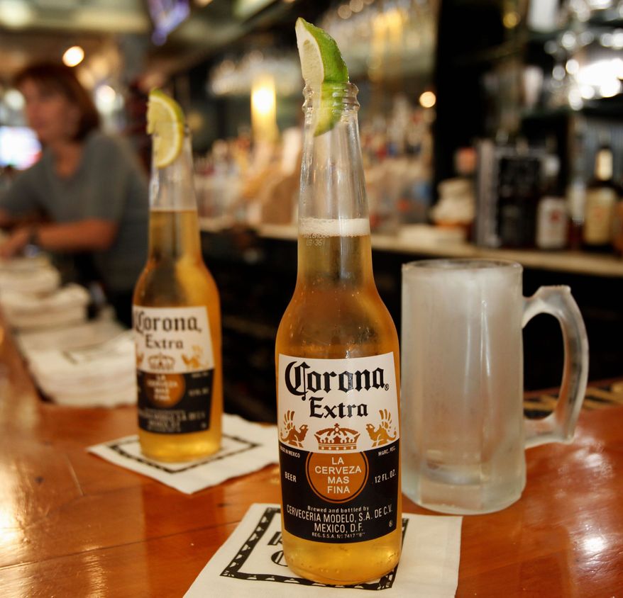 ** FILE ** This Jan. 31, 2013, file photo shows two Corona beers. (Associated Press)