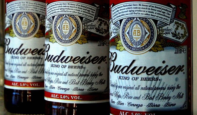 ** FILE ** In this Jan. 27, 2009, file photo, bottles of Budweiser beer are seen at the Stag Brewery in London. Anheuser-Busch InBev SA agreed Friday, June 29, 2012, to buy the half of Corona maker Grupo Modelo it doesn&#x27;t already own for $20.1 billion in cash, in a deal that will greatly increase the size and dominance of the world&#x27;s largest brewer. (AP Photo/Kirsty Wigglesworth, File)