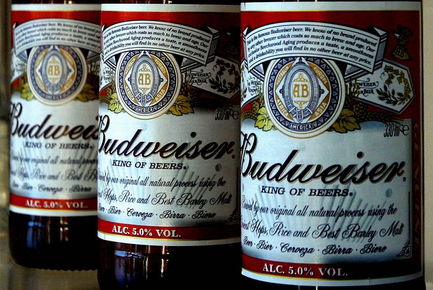 ** FILE ** In this Jan. 27, 2009, file photo, bottles of Budweiser beer are seen at the Stag Brewery in London. Anheuser-Busch InBev SA agreed Friday, June 29, 2012, to buy the half of Corona maker Grupo Modelo it doesn't already own for $20.1 billion in cash, in a deal that will greatly increase the size and dominance of the world's largest brewer. (AP Photo/Kirsty Wigglesworth, File)