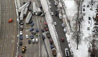 Emergency personnel respond at the scene of one of a mile-long series of crashes along Interstate 75 near the Springwells exit on the southwest side of Detroit Thursday, Jan. 31. At least three people are dead, including two children, and 20 more were injured in the pileups. (Associated Press) 