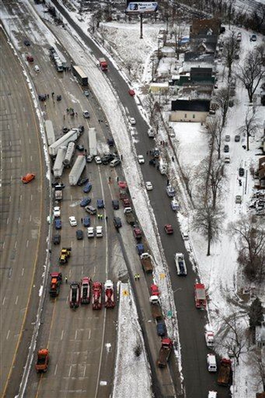 Emergency personnel respond at the scene of one of a mile-long series of crashes along Interstate 75 near the Springwells exit on the southwest side of Detroit Thursday, Jan. 31. At least three people are dead, including two children, and 20 more were injured in the pileups. (Associated Press)