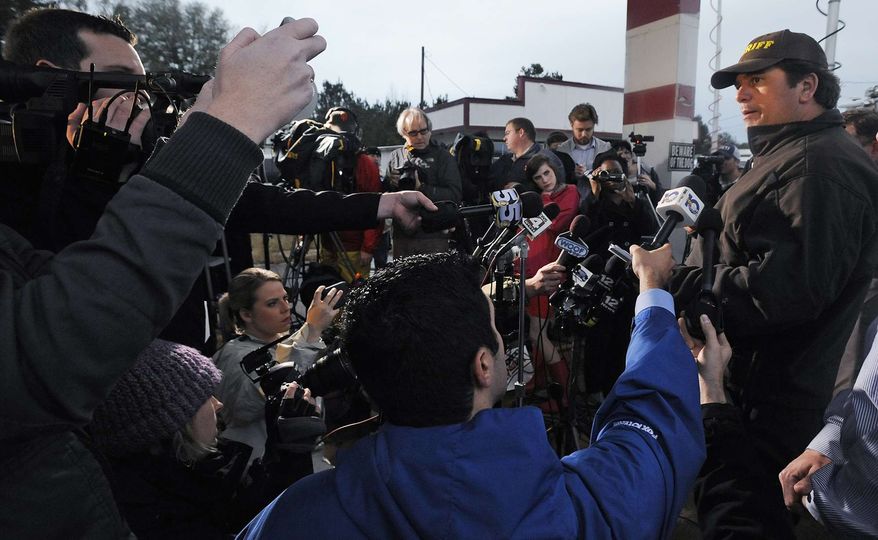 Dale County Sheriff Wally Olsen, right, briefs the media at the Dale County hostage scene in Midland City, Ala., on Wednesday, Jan. 30, 2013. (AP Photo/Montgomery Advertiser, Mickey Welsh)